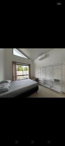 a bedroom with a large bed and a window at Casa moderna em Itapoá SC in Itapoa