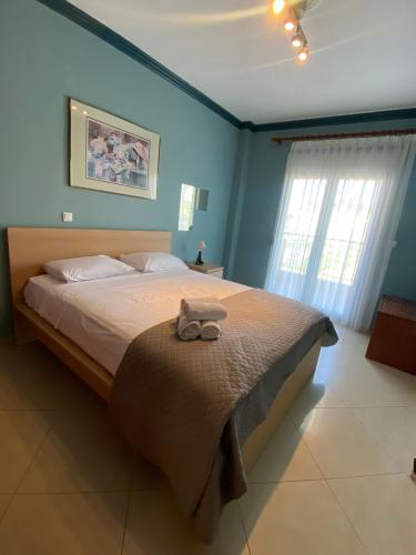 a bedroom with a bed with a stuffed animal on it at SONIA in Kallithea Halkidikis