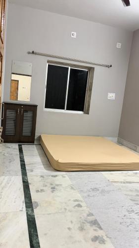 a room with a bed and a window at Cozy Cove 3BHK in Cuttack