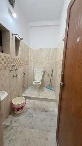 a bathroom with a toilet and a sink at Cozy Cove 3BHK in Cuttack