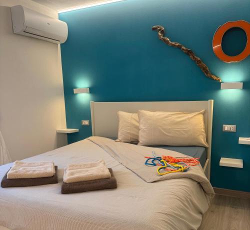 a bedroom with a large bed with two towels on it at L4K3 Luxury Apartment - Lake View, Free Pool, Balcony, 50 m to Lake & Historic Center, 90 m2 in Pisogne