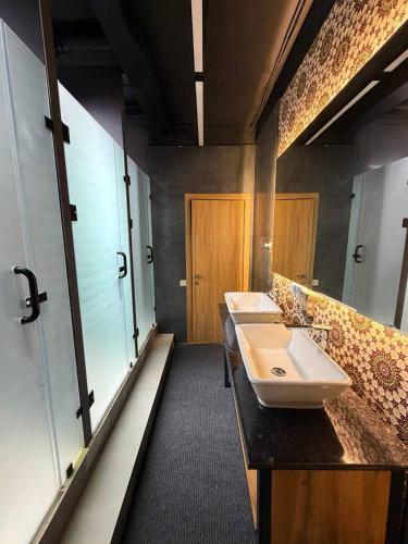 a bathroom with two sinks in a room at The Loft Hostel in Tashkent