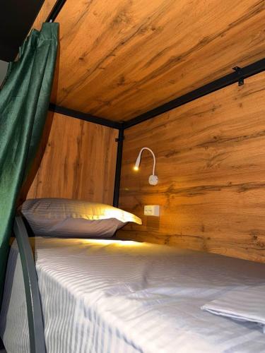 a bedroom with two beds in a wooden cabin at The Loft Hostel in Tashkent