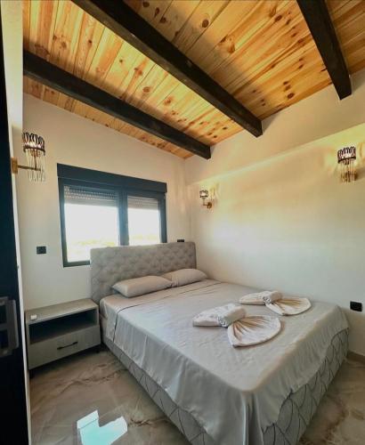 a bedroom with a bed with two towels on it at Vile Relax in Donji Štoj