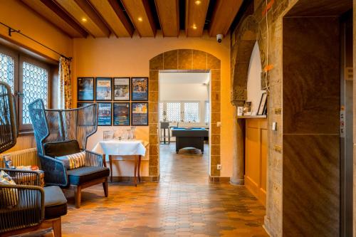 a hallway with a chair and a table in a room at Aparthotel Deutschmeister in Bad Mergentheim