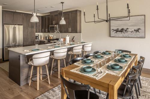 a kitchen with a large wooden table with chairs at Mountain Lake Condo Unit 402D in Big Sky