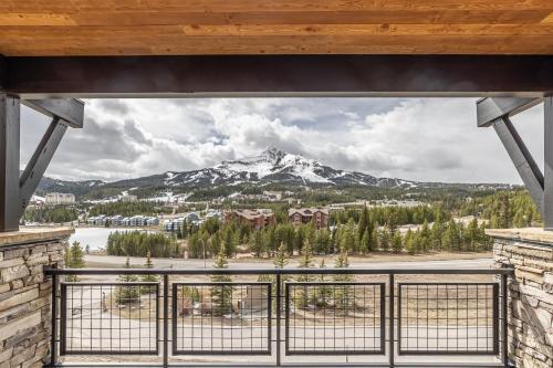 a view of a snow covered mountain from a balcony at Mountain Lake Condo Unit 402D in Big Sky