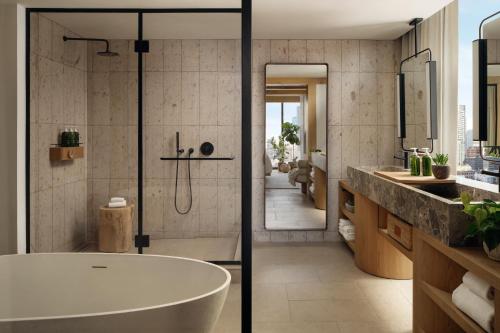 a bathroom with a bath tub and a sink at 1 Hotel Austin in Austin