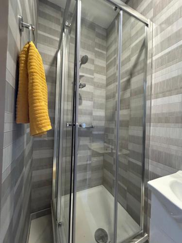 a shower with a glass door in a bathroom at S5 Private Ensuite Room for Professionals AND contractors LNG Grain digs in Gillingham
