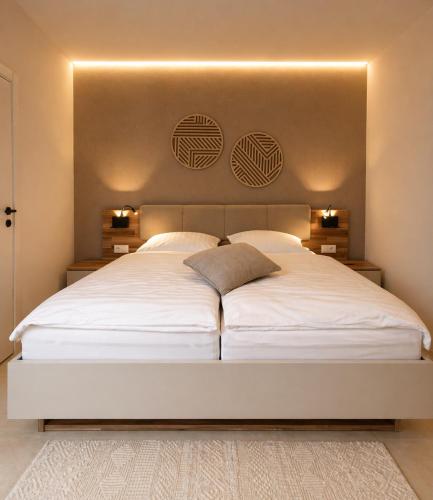 a bedroom with a large white bed with lights on it at Sindelfingen Apartments in Sindelfingen