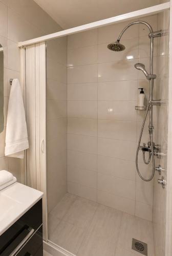 a shower with a glass door in a bathroom at Ninche's Penthouse - free private parking in Pljevlja