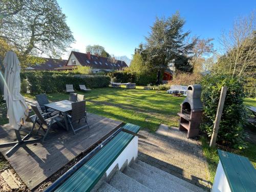 a patio with a table and a grill in a yard at Landdomiziel in Damerow