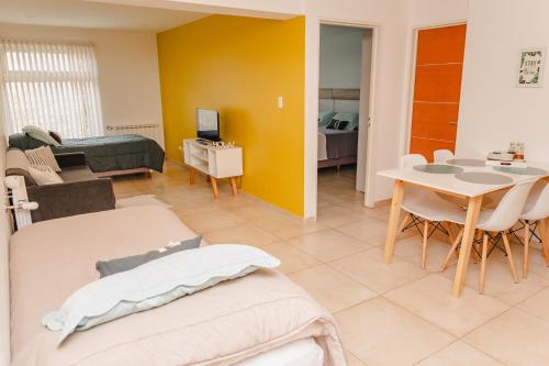 a living room with a table and a dining room at RGA Apartments in Río Grande