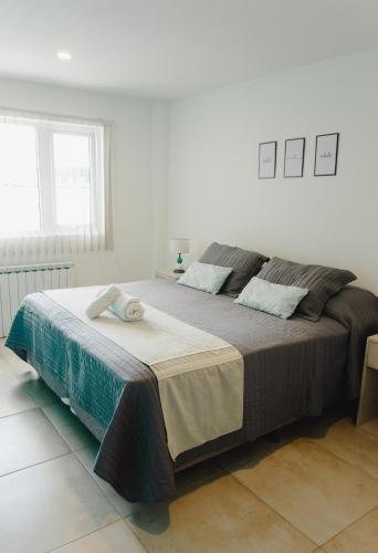 a bedroom with a large bed in a white room at RGA Apartments in Río Grande