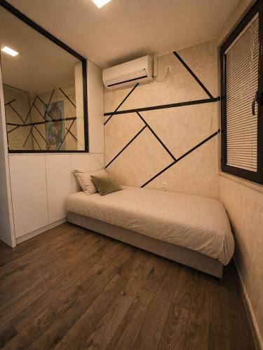 a bedroom with a bed and a painting on the wall at Ninche's Penthouse - free private parking in Pljevlja