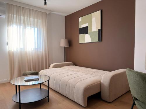 a living room with a large bed and a table at Marea Apartment in Bar