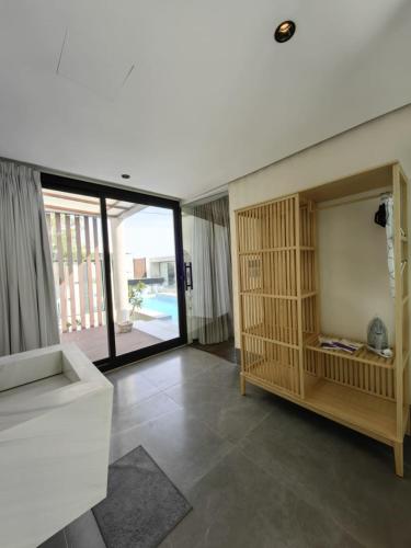 a living room with a large sliding glass door at منتجع تربل فور - Triple Four Resort in Buraydah