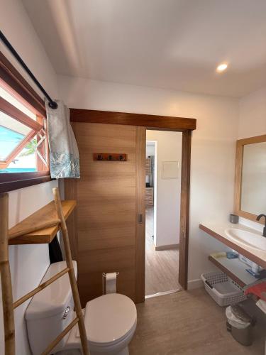a bathroom with a toilet and a sink at Le TeRava - Beach House in Ataiti
