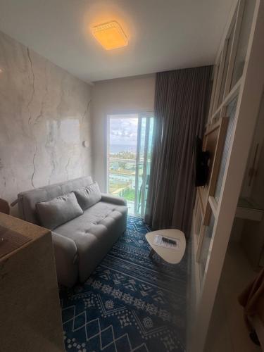 a living room with a couch and a large window at 808 Vista para o Mar in Salvador