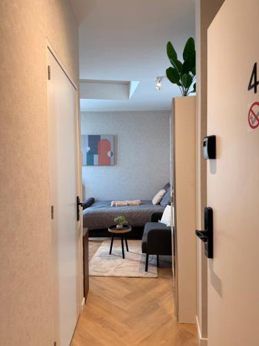 a hallway leading to a living room with a couch at Modern luxury studio near City Center Eindhoven in Eindhoven