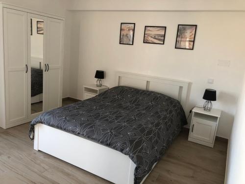 a bedroom with a bed and two tables with lamps at Casa Dulcelina Monte Gordo, Algarve, Portugal in Monte Gordo