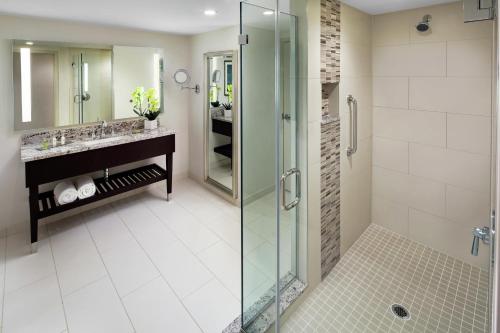 a bathroom with a glass shower and a sink at DoubleTree by Hilton Manchester Downtown in Manchester