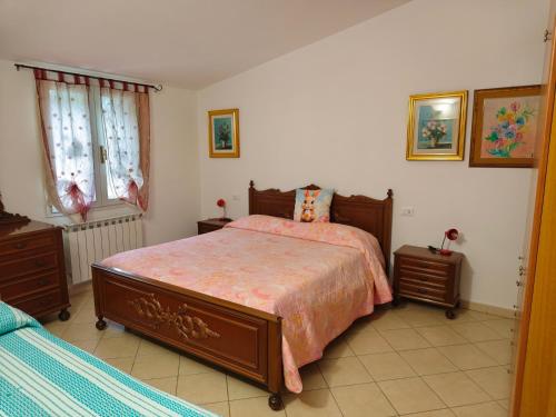 a bedroom with a large bed and two night stands at Soleluna in Levanto