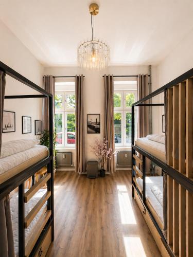 a bedroom with two bunk beds and a chandelier at Berlin Sleep Club in Berlin