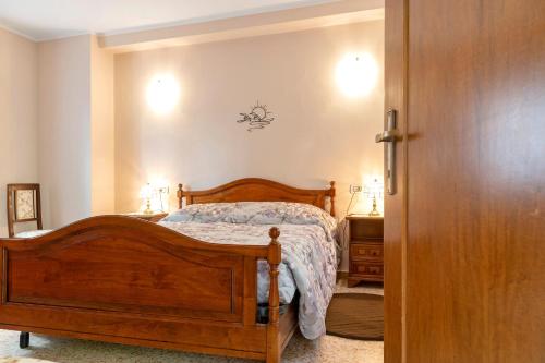 a bedroom with a wooden bed and two night stands at La casetta in Marzio