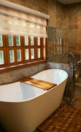 a large bath tub in a bathroom with a window at Quinta San Ignacio in Guadalajara