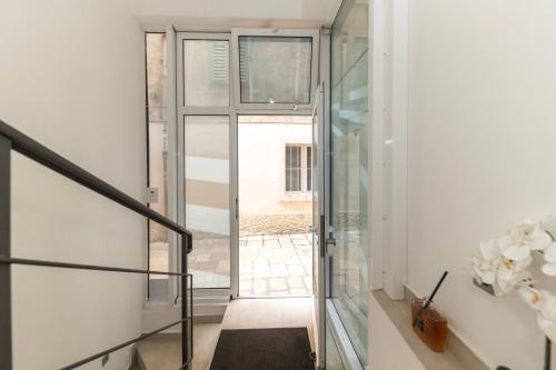 a hallway with a glass door leading to a courtyard at CentRooms Kovac1 in Zadar