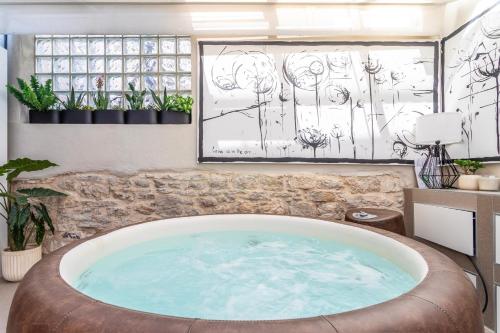 a hot tub in a room with drawings on the wall at Apartment Luxury Palace No1 in Split