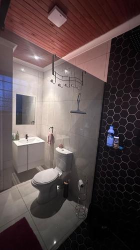 a bathroom with a white toilet and a sink at The Kempton Star in Kempton Park