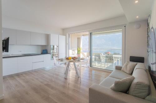 a living room with a couch and a table at Valarin Residence & Villa Valarin Elite by Rent All Como in Vercana