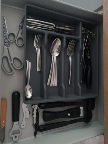 a drawer filled with utensils in a kitchen at Appart' Cosy proche Mulhouse in Illzach