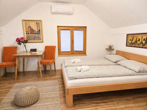 a bedroom with a bed and a table and chairs at Airport Studio Loft - Galleria in Belgrade