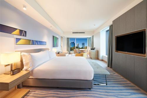 a hotel room with a bed and a television at Doubletree By Hilton Perth Waterfront in Perth
