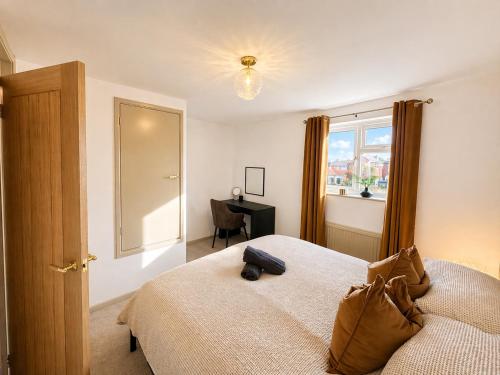a bedroom with a bed and a window at Golden Sands Escape Weymouth Entire House in Wyke Regis