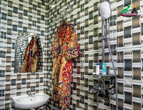 a bathroom with a sink and a mirror at Legacy Chillout Kasese in Kasese