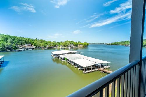 a dock on a river with boats in the water at Sunset Lakefront Retreat with Luxe Upgrades in Osage Beach