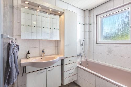 a bathroom with a sink and a shower and a tub at K8 Living in Wehr