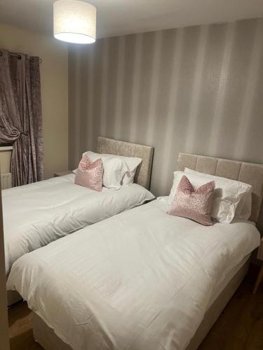 two beds sitting next to each other in a room at The Clady Home in Clady