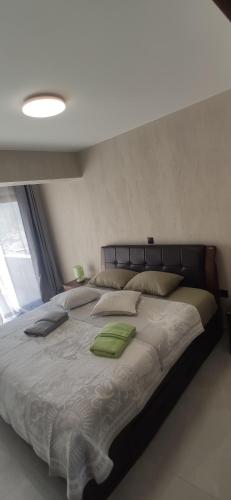 a bedroom with a large bed with green pillows at Ocean and Mountain View T2 N-3 in Lazareto