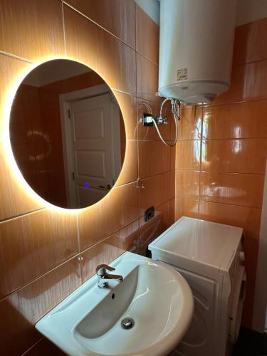 a bathroom with a sink and a mirror at Sol & Sea Apartments in Shëngjin