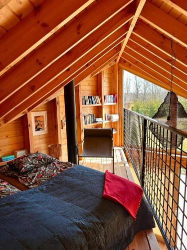 a bedroom with a large bed in a cabin at Trzy Siostry Udryn in Udryń