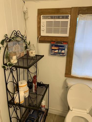 a bathroom with a toilet and a air conditioner at The Pearl in Fort Walton Beach