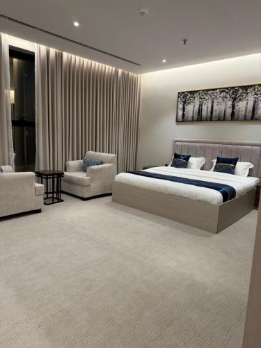 a bedroom with a king sized bed and a couch at كلود فيو in Abha