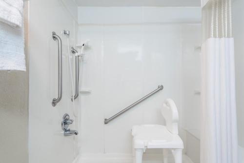 a white bathroom with a shower and a toilet at Red Carpet Inn Lancaster in Lancaster