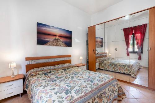 a bedroom with a bed and a mirror at Casa Sciura in San Vito lo Capo