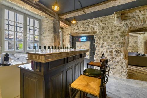 a bar in a room with stone walls at Chateau- La Providence in Satillieu